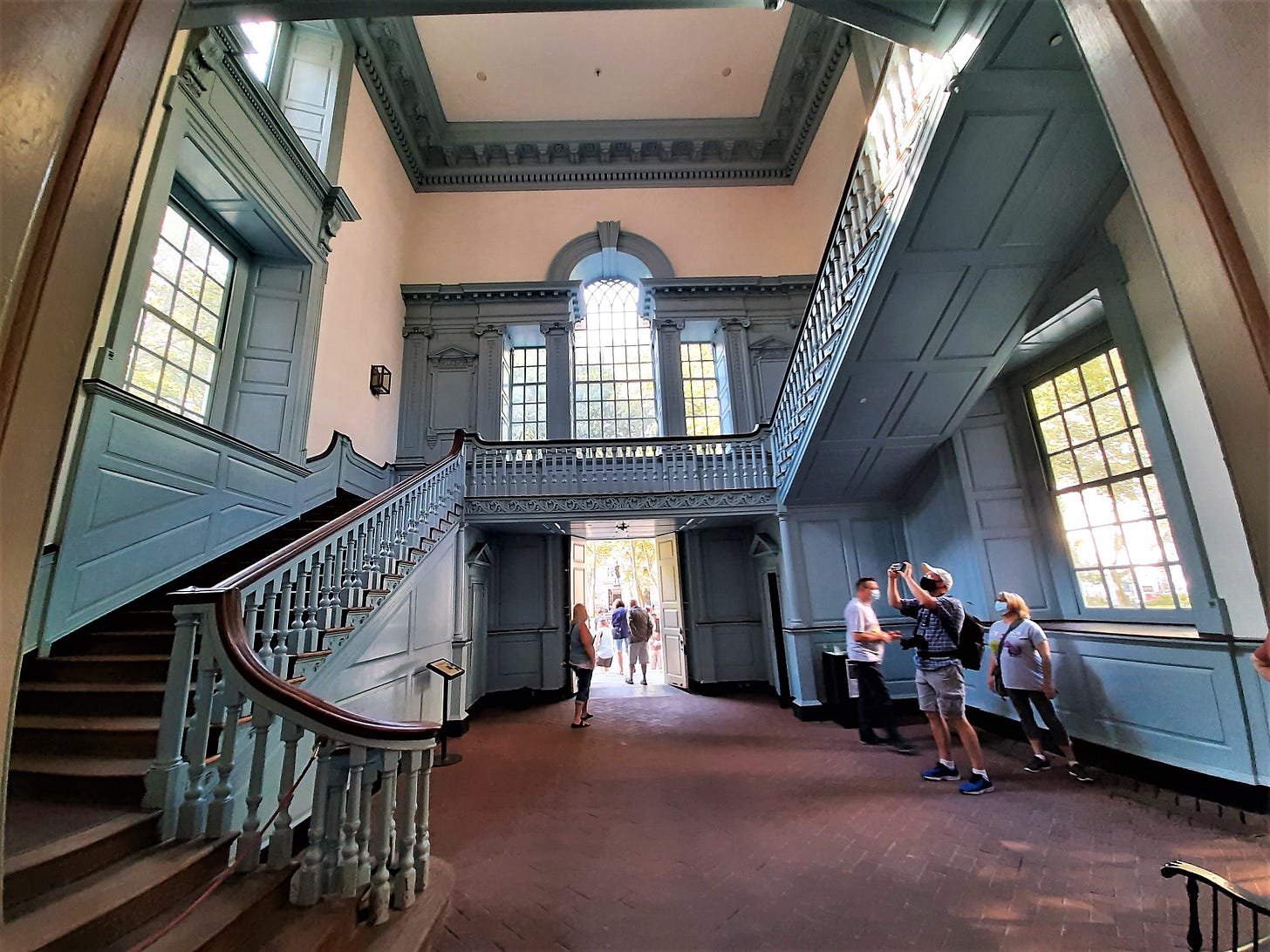 Blue stairway with large windows inside Independence Hall