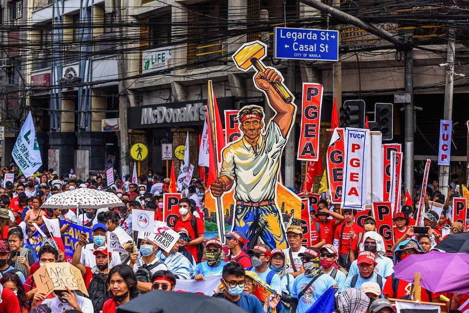 Workers carrying banners and placards march along España Boulevard in Manila on Monday, May 1, 2023 in celebration of the International Labor Day. The workers called for higher wages, respect for labor rights, right to organize, and freedom of association during the protest march. Maria Tan, ABS-CBN News