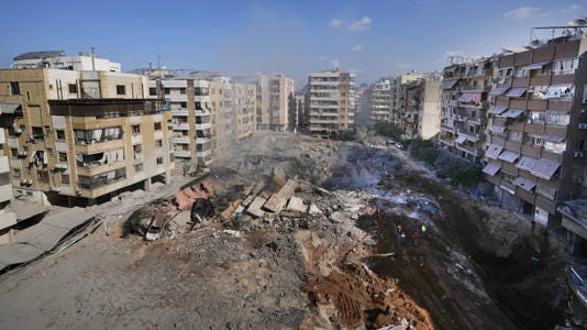 People gather at the site of the assassination of Hezbollah's leader Hassan Nasrallah in Beirut's southern suburbs on Sunday, September 29, 2024. - Hassan Ammar/AP