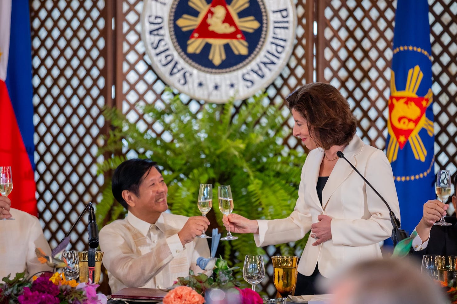 Commerce Secretary Gina Raimondo and President Ferdinand Marcos Jr. raising a toast.