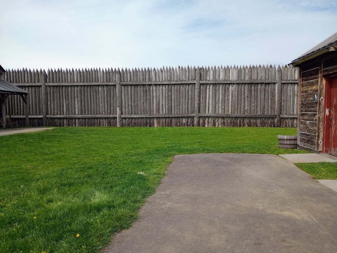 Tight high wall of fencing with spiked poles