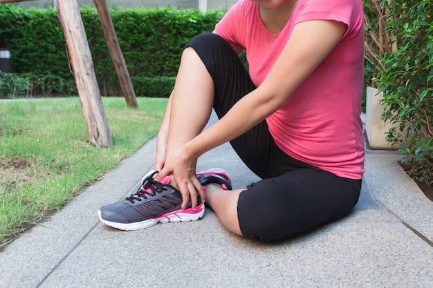 Sporty woman ankle sprain while jogging or running at park