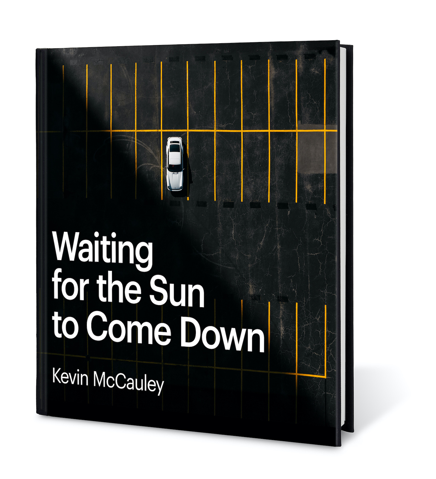 The cover of Waiting for the Sun to Come Down by Kevin McCauley, an automotive photography book highlighting the contrast of light and shadow on some of the world's coolest cars. The cover features a white Porsche top-down view on a black parking lot, a diagonal shadow crossing it from one corner to another.