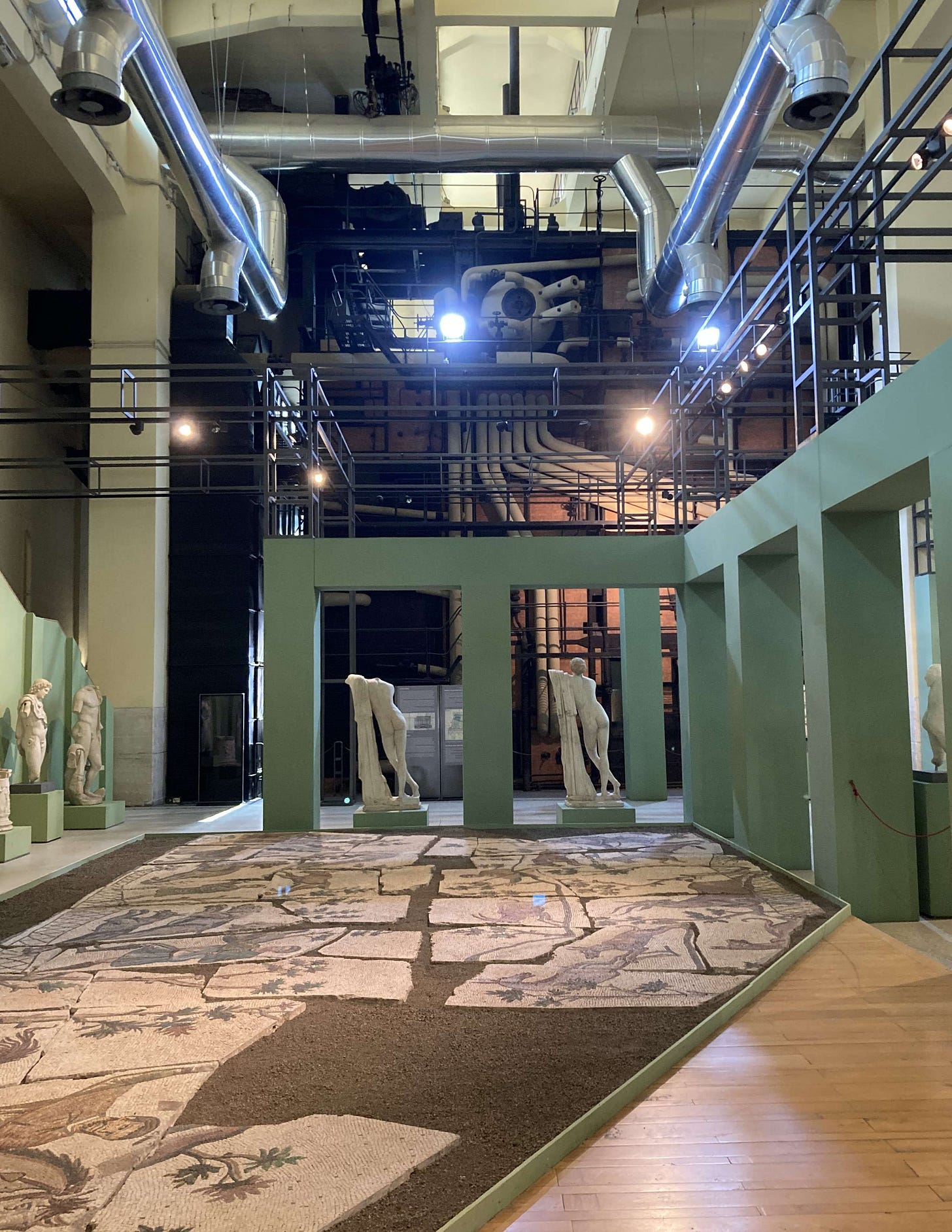 A museum showing Roman floor mosaic, some marble statues and piping from the old power station.