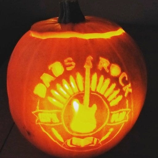 lit pumpkin carved with logo for Dads Rock charity