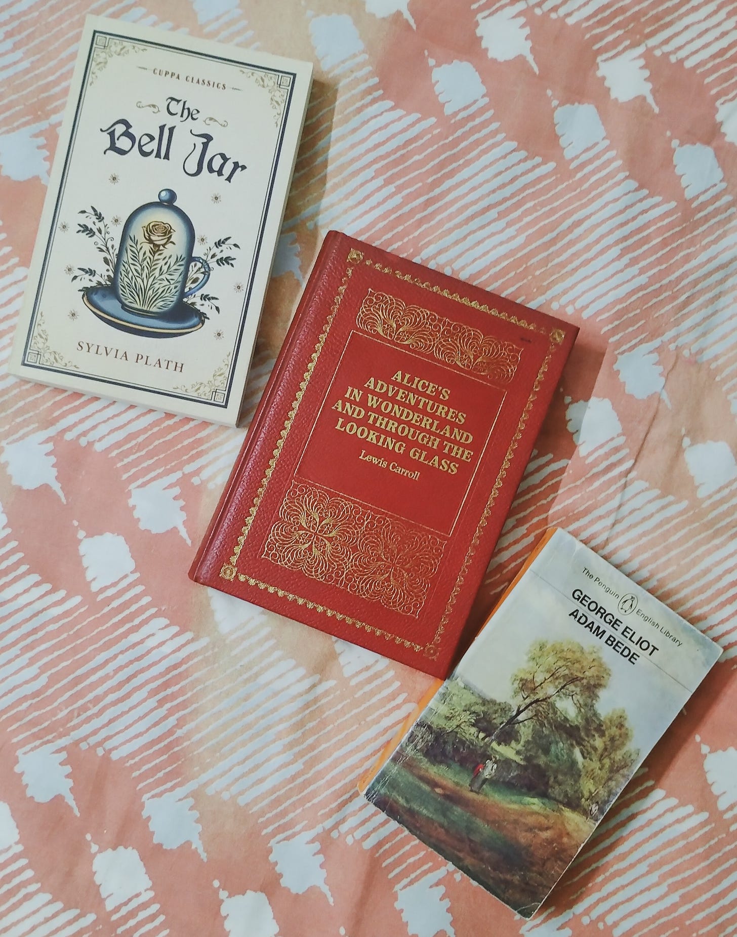 Alice’s Adventures In Wonderland by Lewis Carroll, Adam Bede by George Eliot, and The Bell Jar by Sylvia Plath