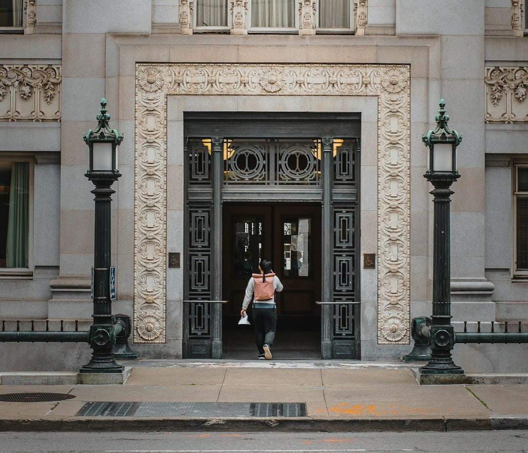 a man and a woman standing in front of a building