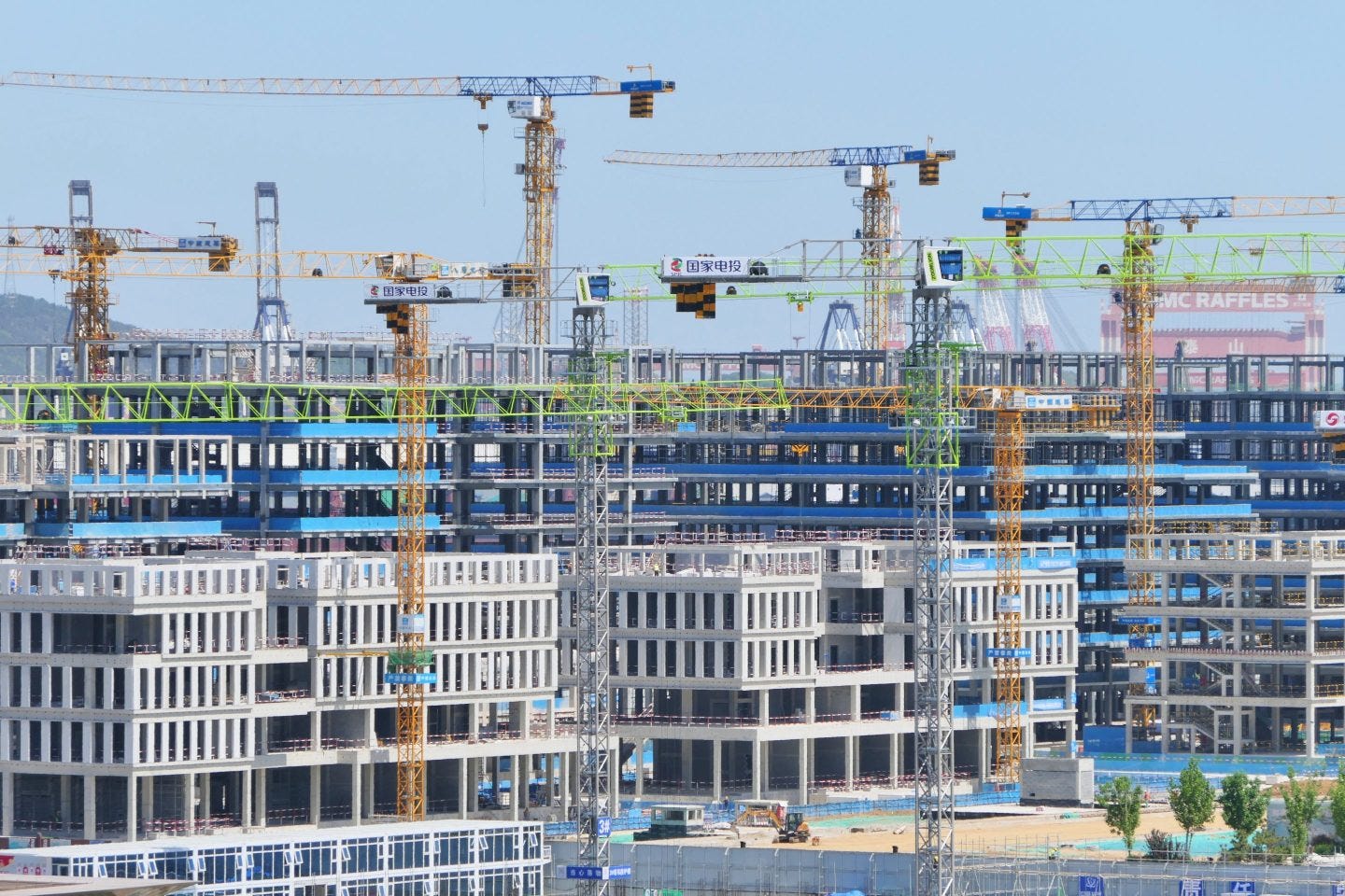 Tower cranes are seen at a real estate construction site in Yantai, Shandong province, China, May 19, 2024. 