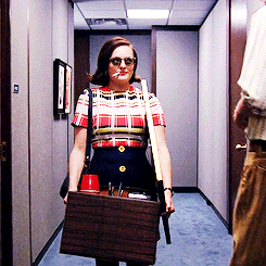 Gif of Peggy Olson from Mad Men walking in slow-motion down the corridor, wearing sunglasses and smoking a cigarette, after she quits her job.