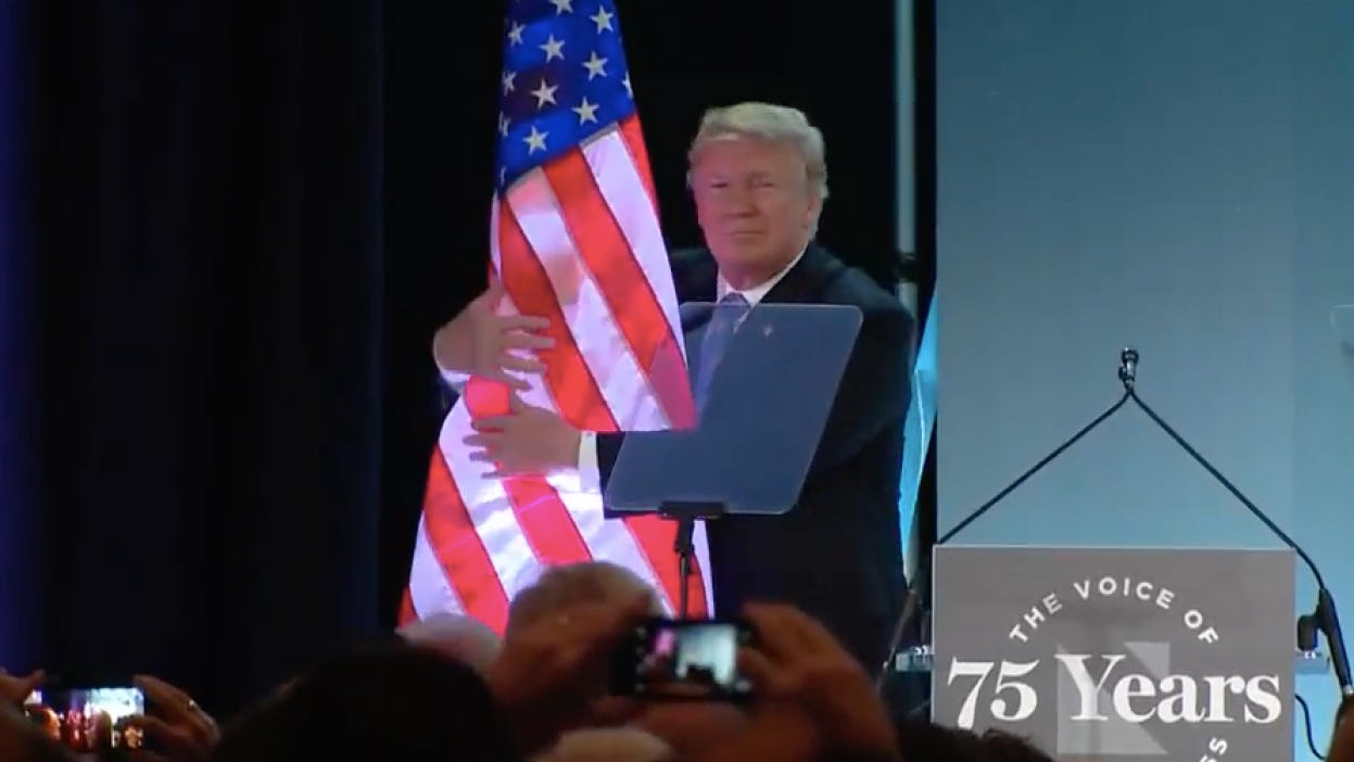 Donald Trump disrespects the American flag by giving it a creepy hug, again