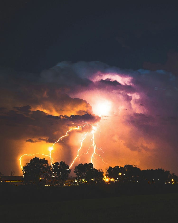 Photograph of lightning with dark clouds.