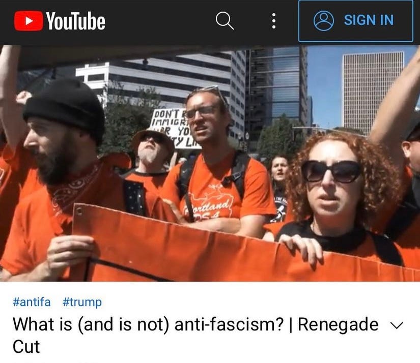 Youtube screenshot of activists in red tshirts at a protest