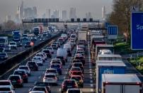 FILE - Cars and trucks queue in a traffic jam on a highway near Frankfurt, Germany, March 28, 2023. The European Union has been at the forefront of the fight against climate change and the protection of nature for years. But it now finds itself under pressure from within to pause new environmental efforts amid fears they will hurt the economy. (AP Photo/Michael Probst, File)