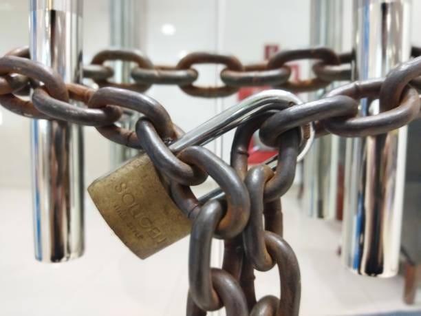 padlock and Chain Chain and Padlock use for lock damaged twin glass door padlocked door modern office stock pictures, royalty-free photos & images