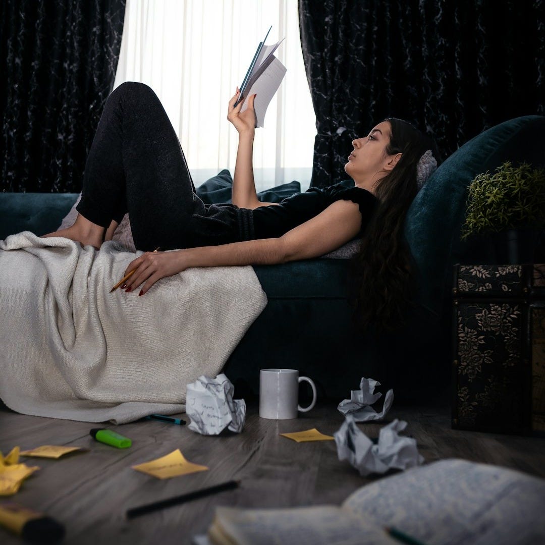 woman in black long sleeve shirt and black pants lying on black couch woman in black long sleeve shirt and black pants lying on black couch