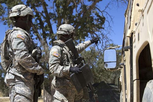 U.S. Army Reserve Spcs. Jahvar Billings and Anthony Clark, 385th Transportation Detachment, Fort Bragg, N.C., guide a Humvee driver during a training exercise at Fort Hunter Liggett, Calif., June 15, 2016. (Army Photo: Spc. Daisy Zimmer)