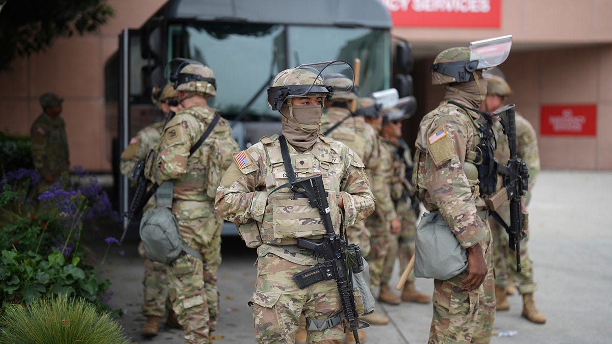 U.S. National Guard members in camo and riot gear
