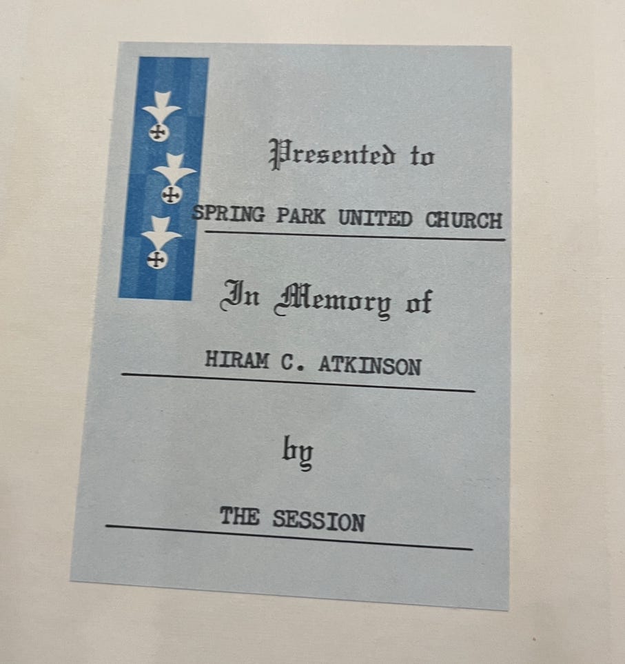 A label inside the cover of a bible saying "presented in memory of Hiram C. Atkinson"