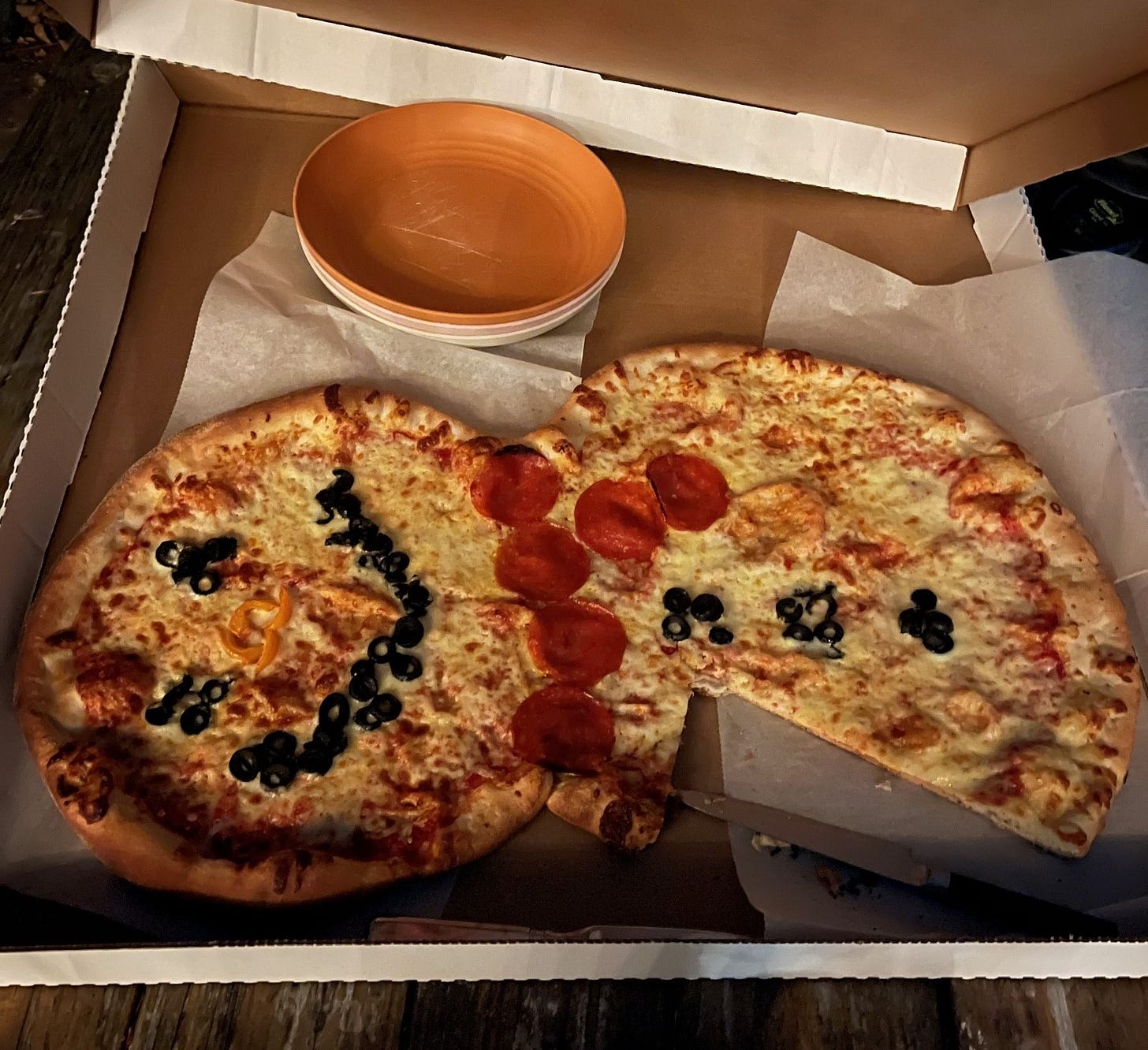 a pizza decorated to look like a snowman