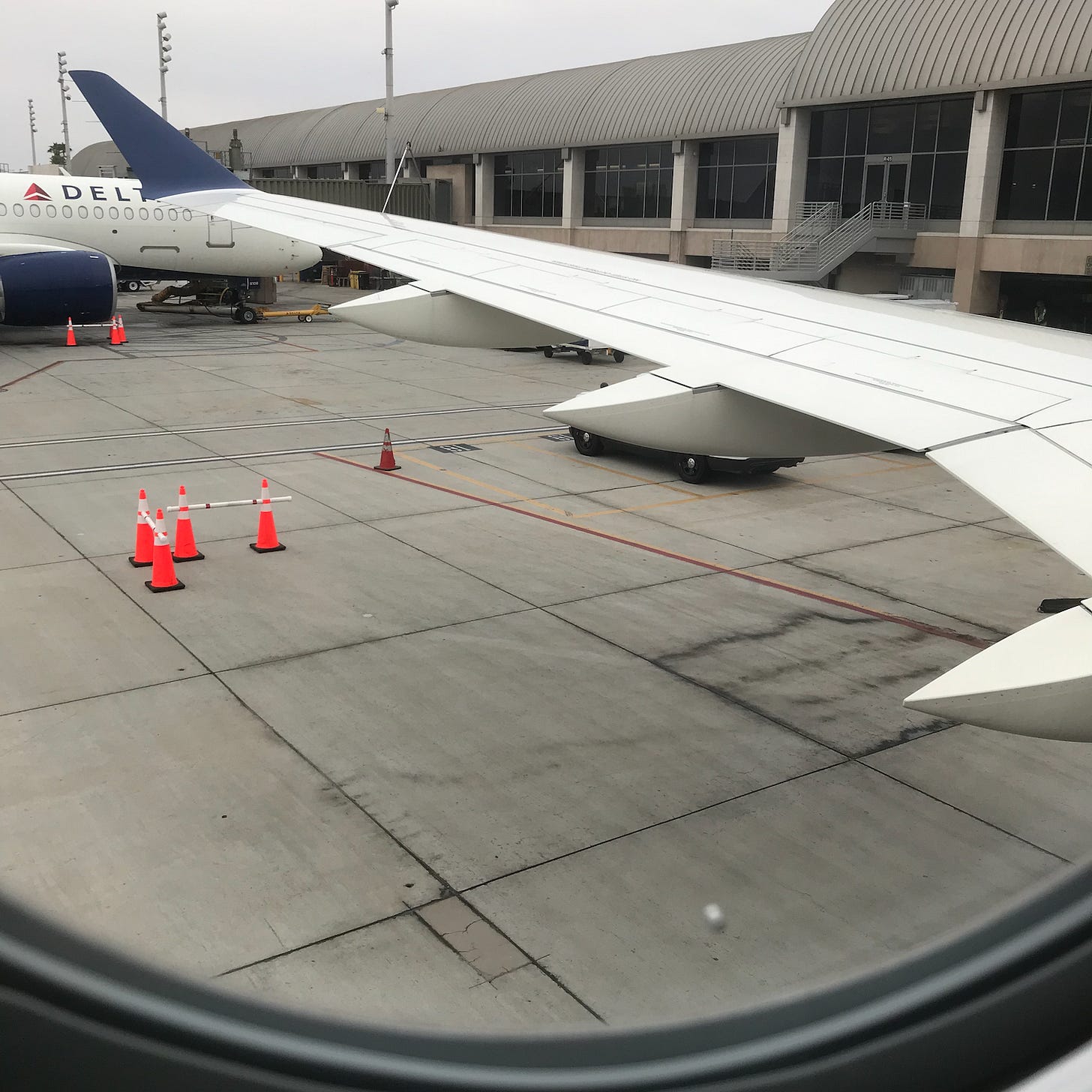 Airplane wing photo taken from window seat on the plane where the author composed today's song addition to the "Mixed Up Files."