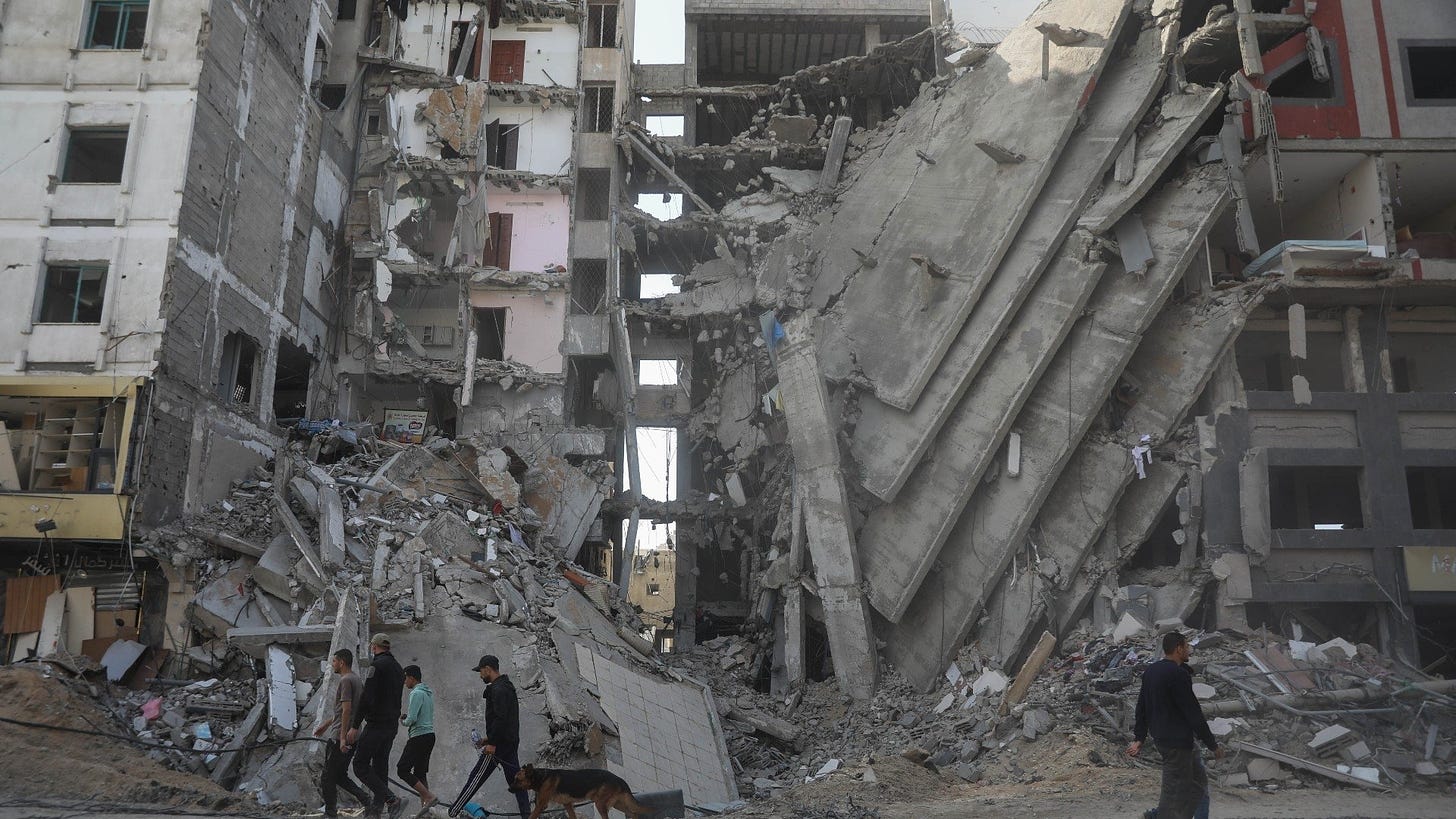 gaza-people-walk-ruins-after-israel-strikes-24-nov-2023-mee