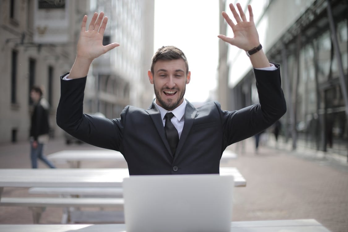 Free Man in Black Suit Raising Both Hands Stock Photo