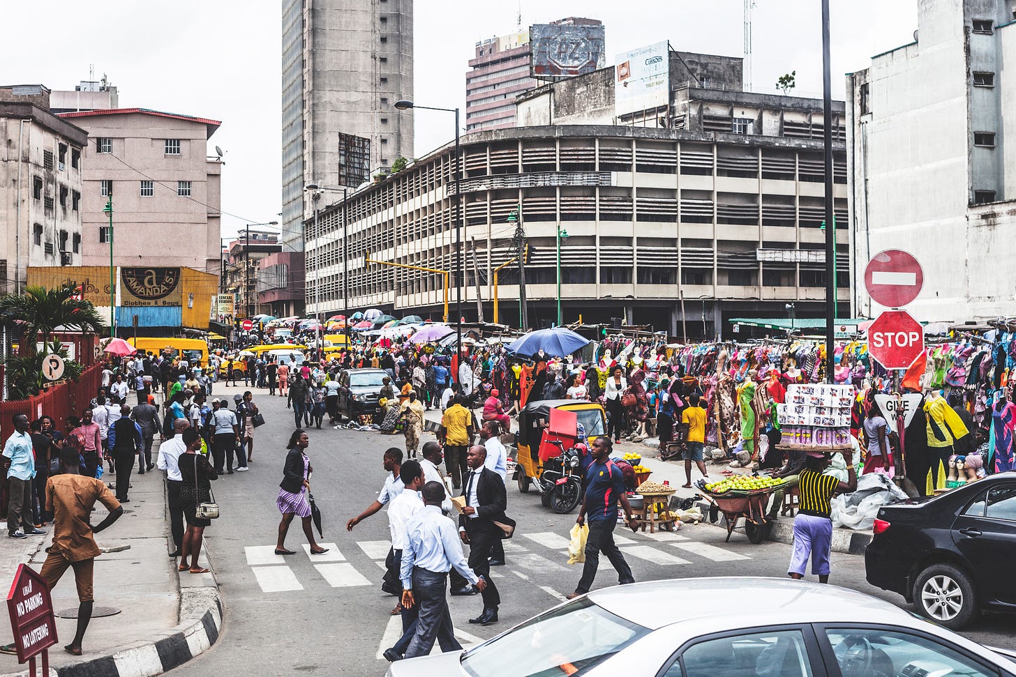Busy downtown Lagos streets with pedestrians and shopping stalls