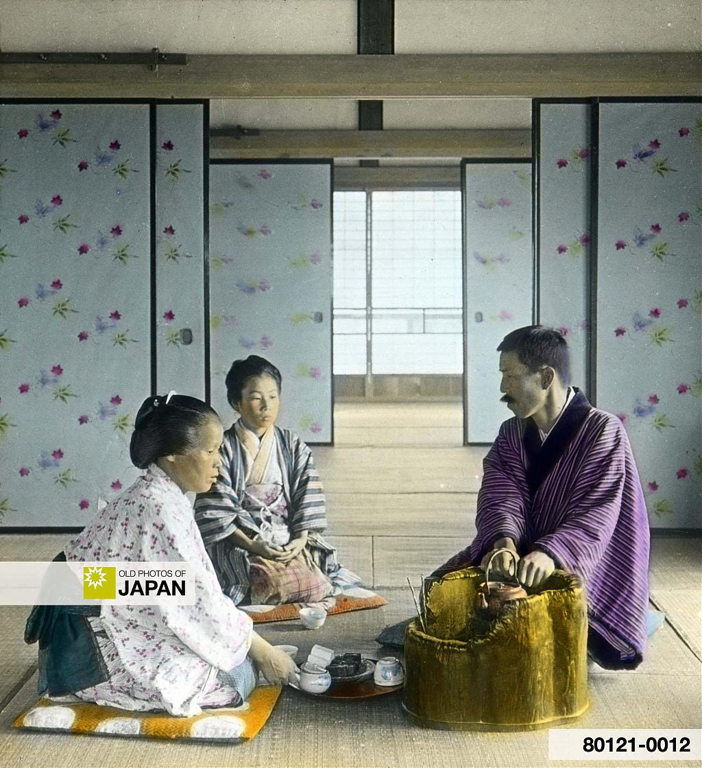 A Japanese man warming his hands at a hibachi brazier, 1920s A Japanese man warming his hands at a hibachi brazier, 1920s