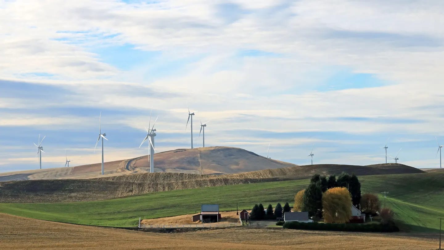 Wind turbines on a hill above a farm home in southeastern Washington state in November.