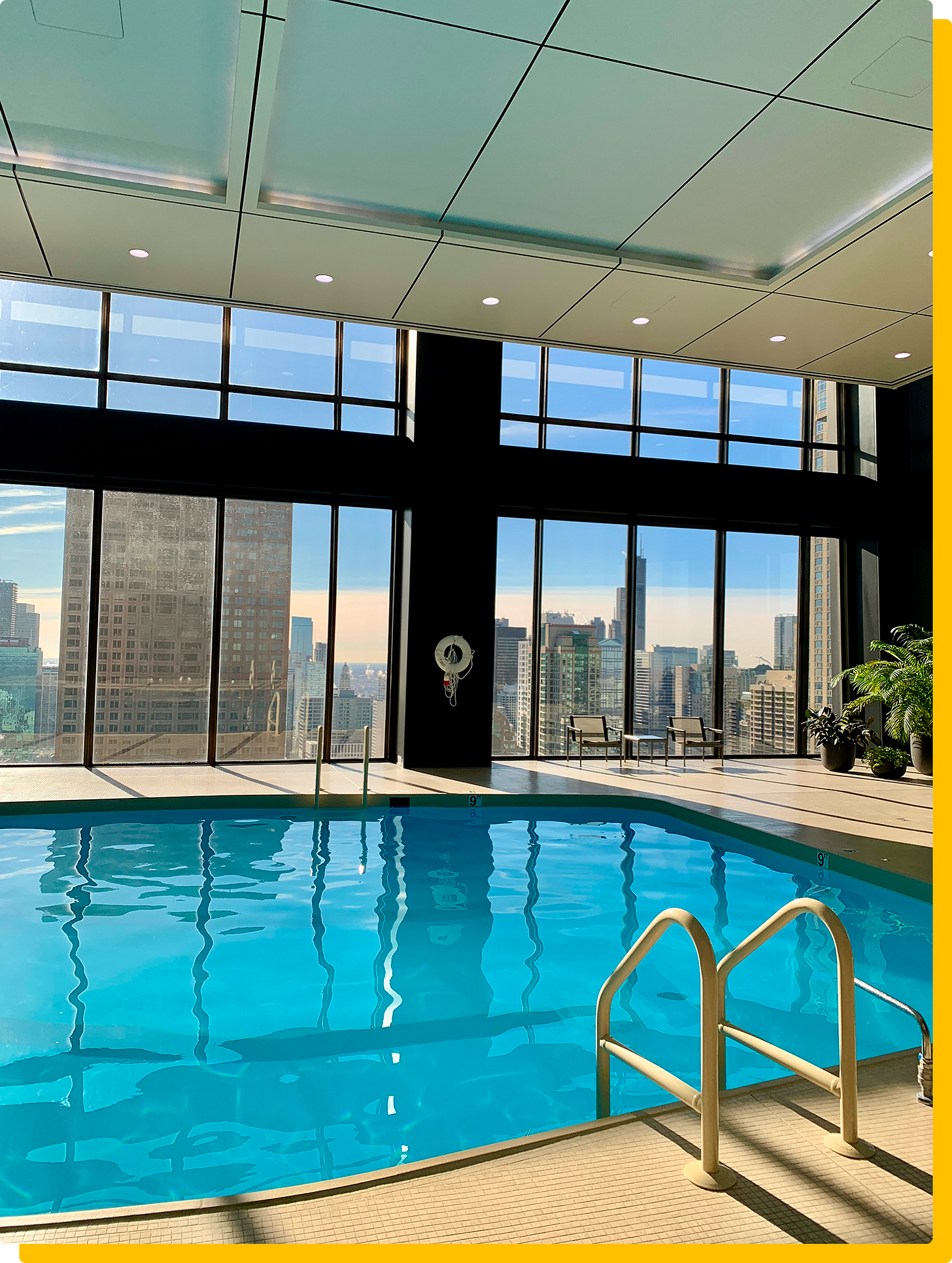 Photo of an indoor pool with a Chicago skyline view