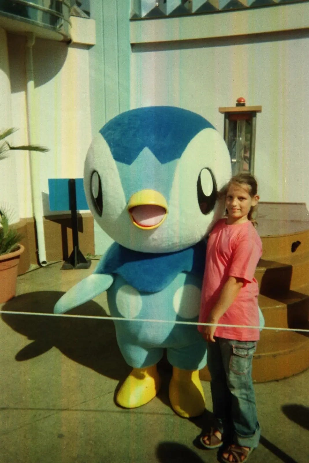 A photograph of Kimberley with a Piplup mascot