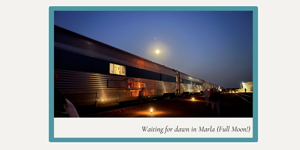 predawn at Marla while traveling on the Ghan, a full moon is visible