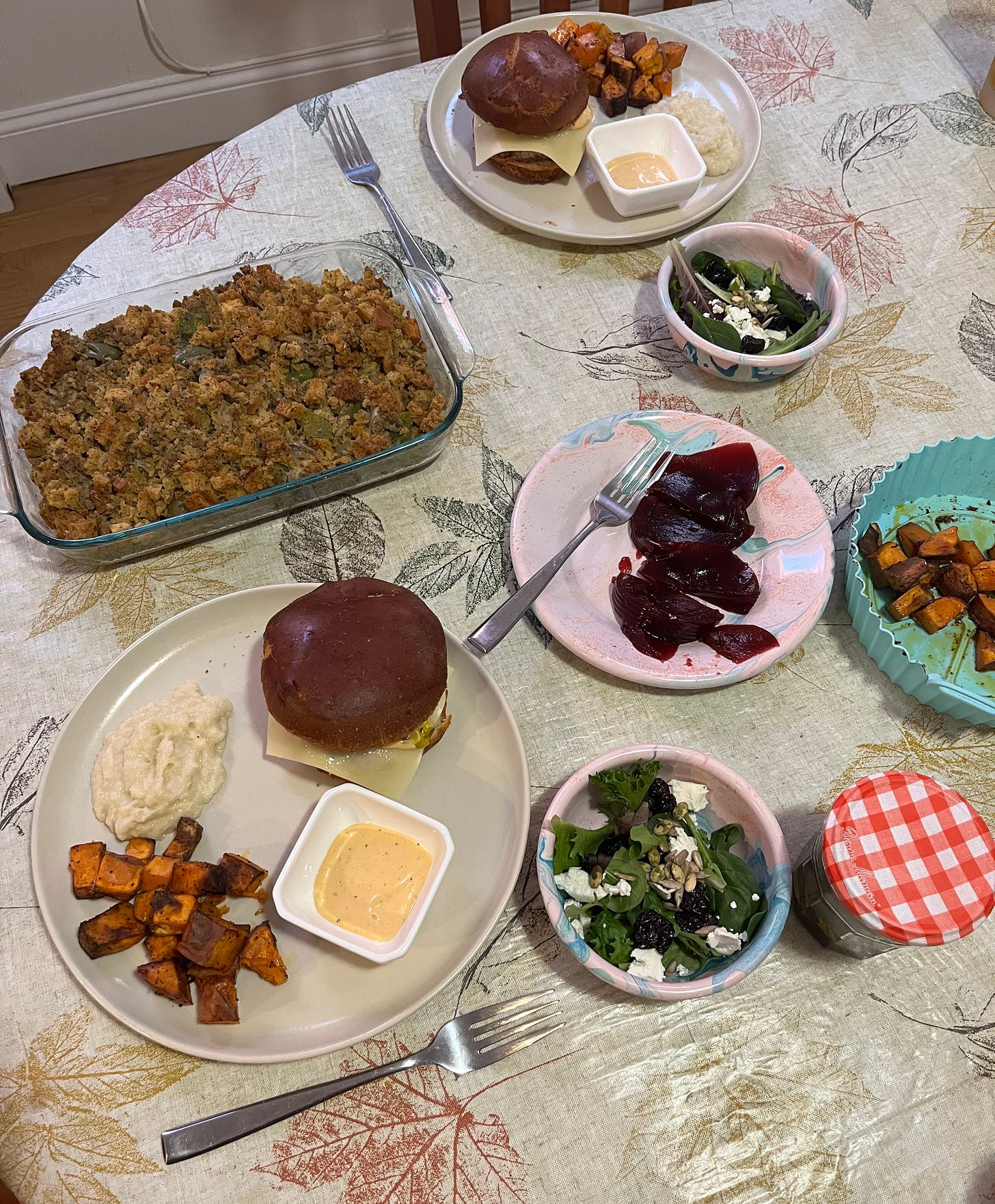 thanksgiving dinner of turkey burgers, sweet potatoes, stuffing, cranberry sauce, and salad