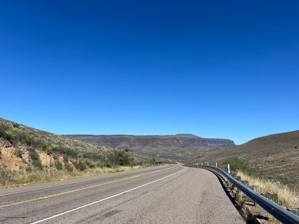 A road with a metal railing

Description automatically generated