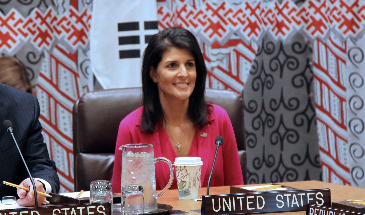 Nikki Haley seated behind a UNITED STATES label.