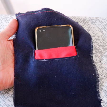 a welt pocket made out of scrap fabrics using a contrasting welt fabric, with a phone in the pocket