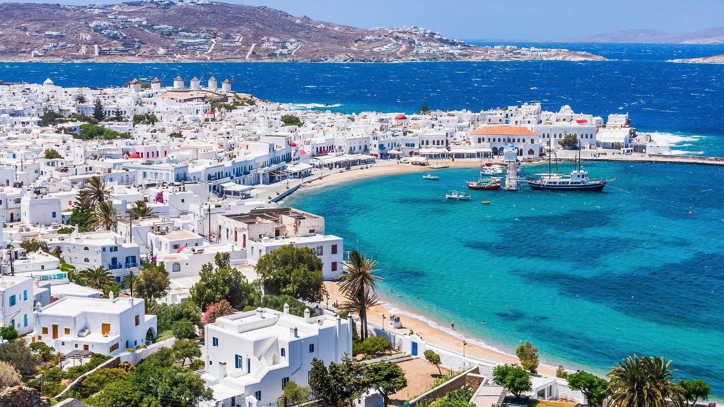 Mykonos coastline aerial view with clear blue waters.