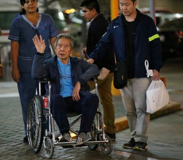 The former Peruvian president Alberto Fujimori waved to supporters beside his son, the congressman Kenji Fujimori, as he was wheeled out of a clinic in Lima in January.