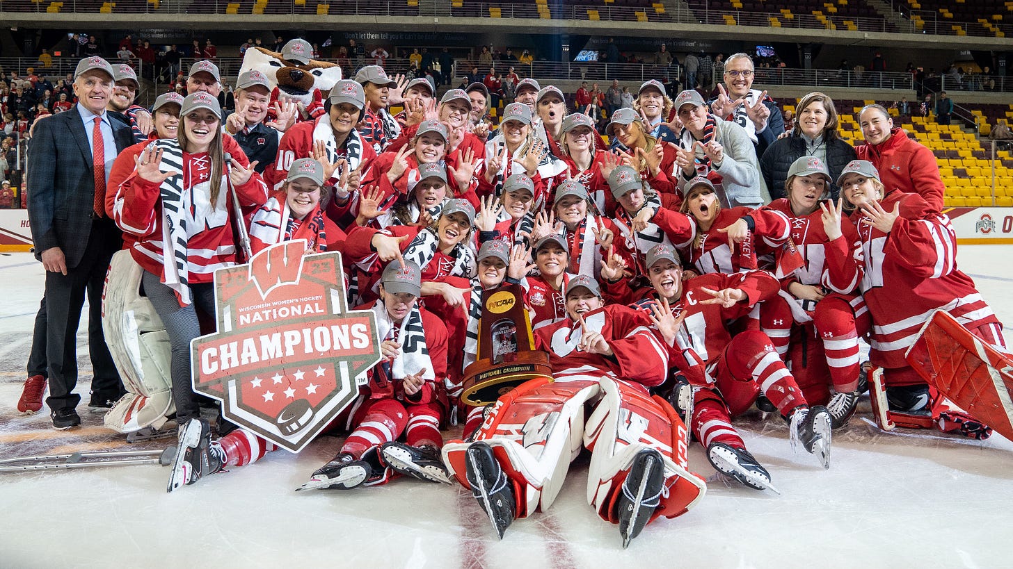 The Wisconsin Women's Hockey team poses for a team photo together on the ice after winning the 2023 NCAA Women's Ice Hockey National Championships at AMSOIL Arean in Duluth, Minnesota.