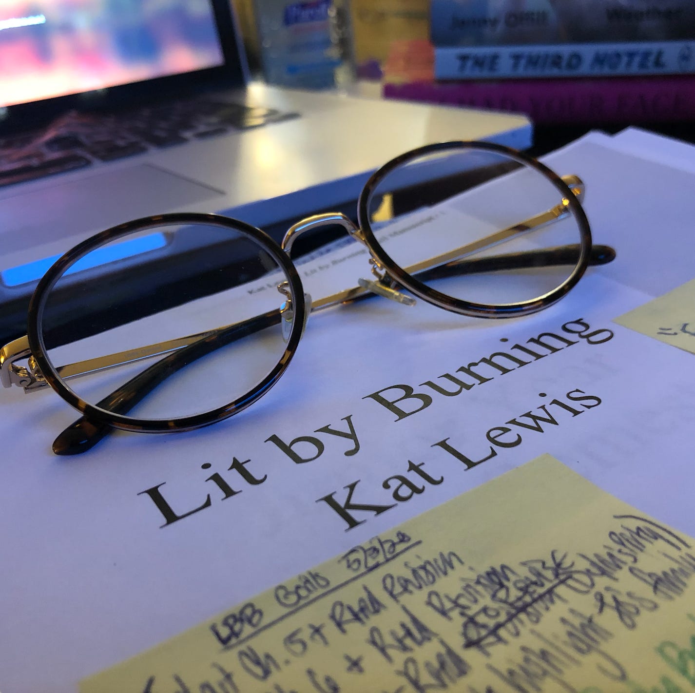 A photo of Kat's printed manuscript for her novel, Lit by Burning. It's dated May 2020.