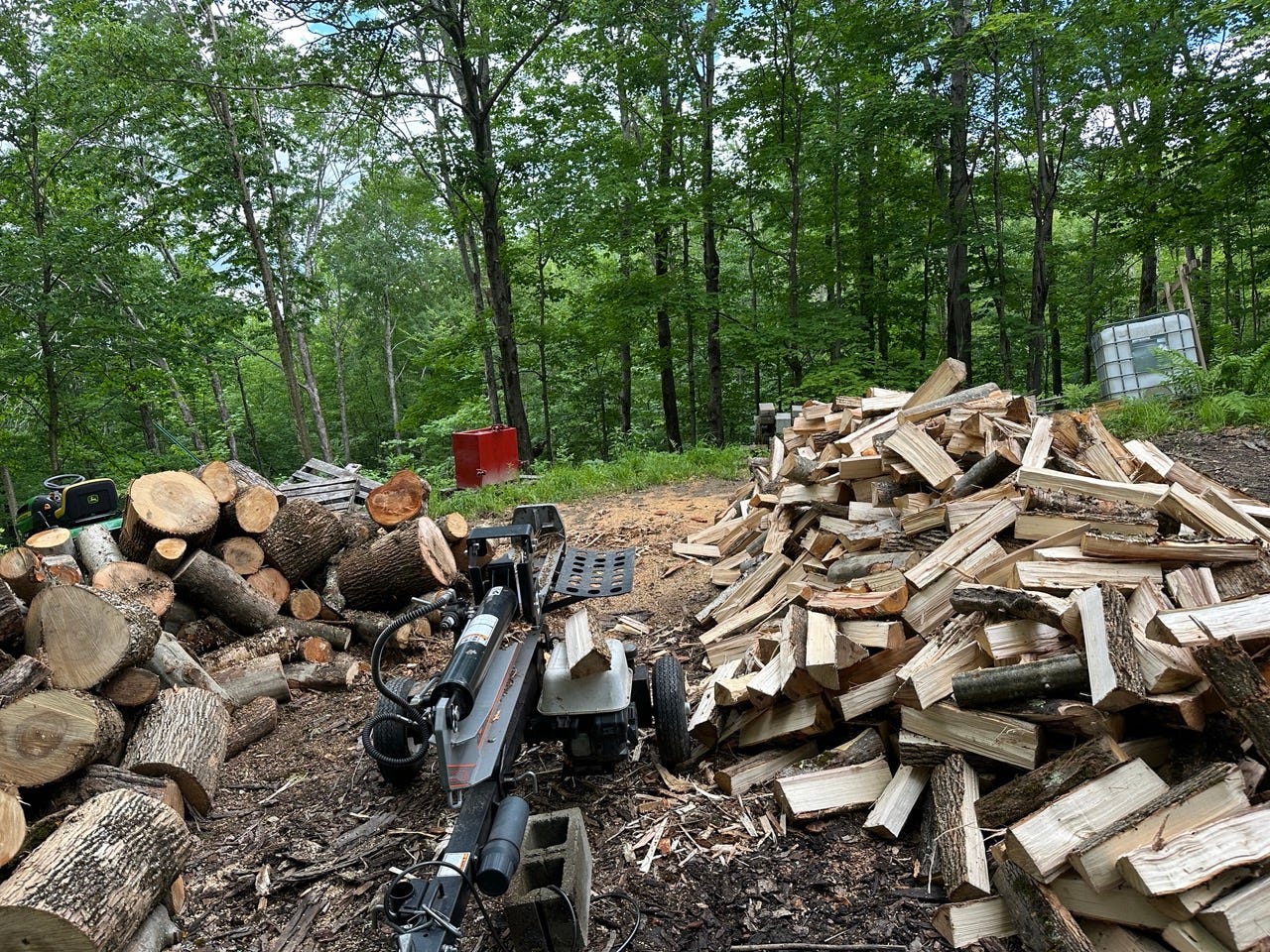 Pile of firewood and wood splitter used by Jesse McEntee