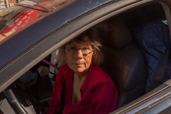 Mrs. Shaw sitting in the driver's seat of her car.