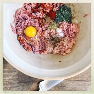 A mix of minced chicken and pork with an egg, herbs and spices. Ready to be shaped into a burger.