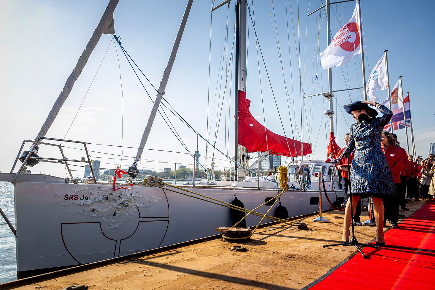 Queen Maxima watches a bottle smash against a boat