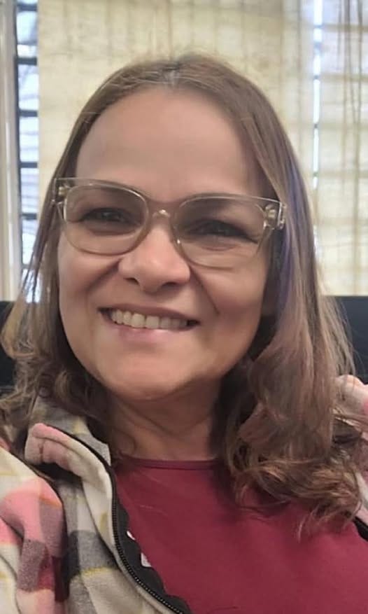 May be an image of 1 person, smiling and eyeglasses