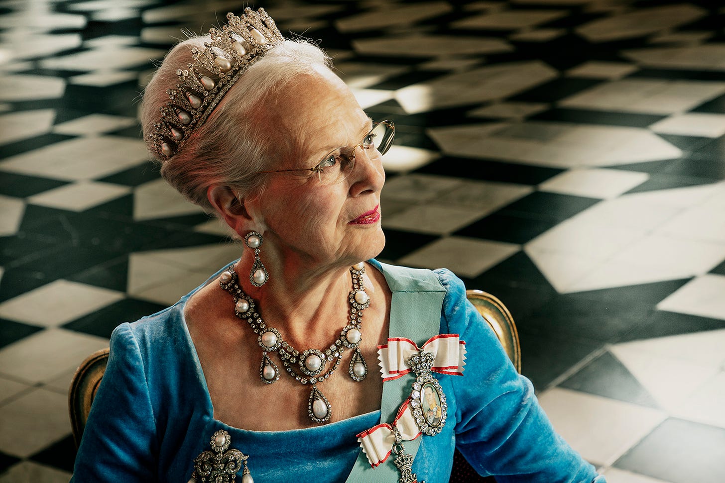 Queen Margrethe of Denmark smiling and wearing tiara and jewellery
