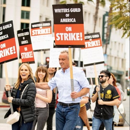 Presidential candidate Robert F Kennedy, Jr and wife, actress Cheryl Hines, with striking Writers Guild of America (WGA) writers on the picket line in Los Angeles, CA.