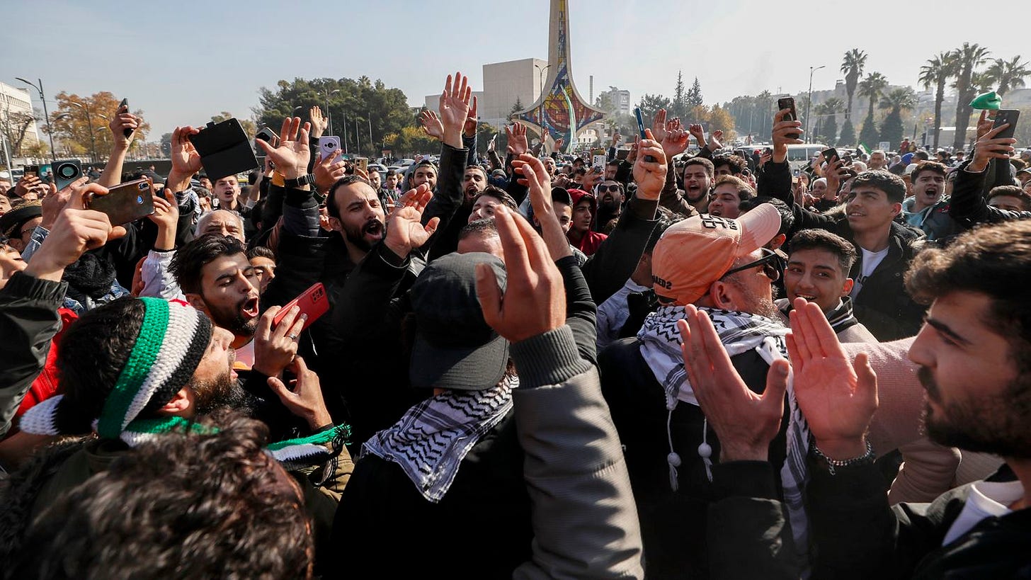 Syrians celebrate at Omayyad Square in Aleppo, Syria, Monday, Dec. 9, 2024. (AP Photo/Omar Sanadiki)