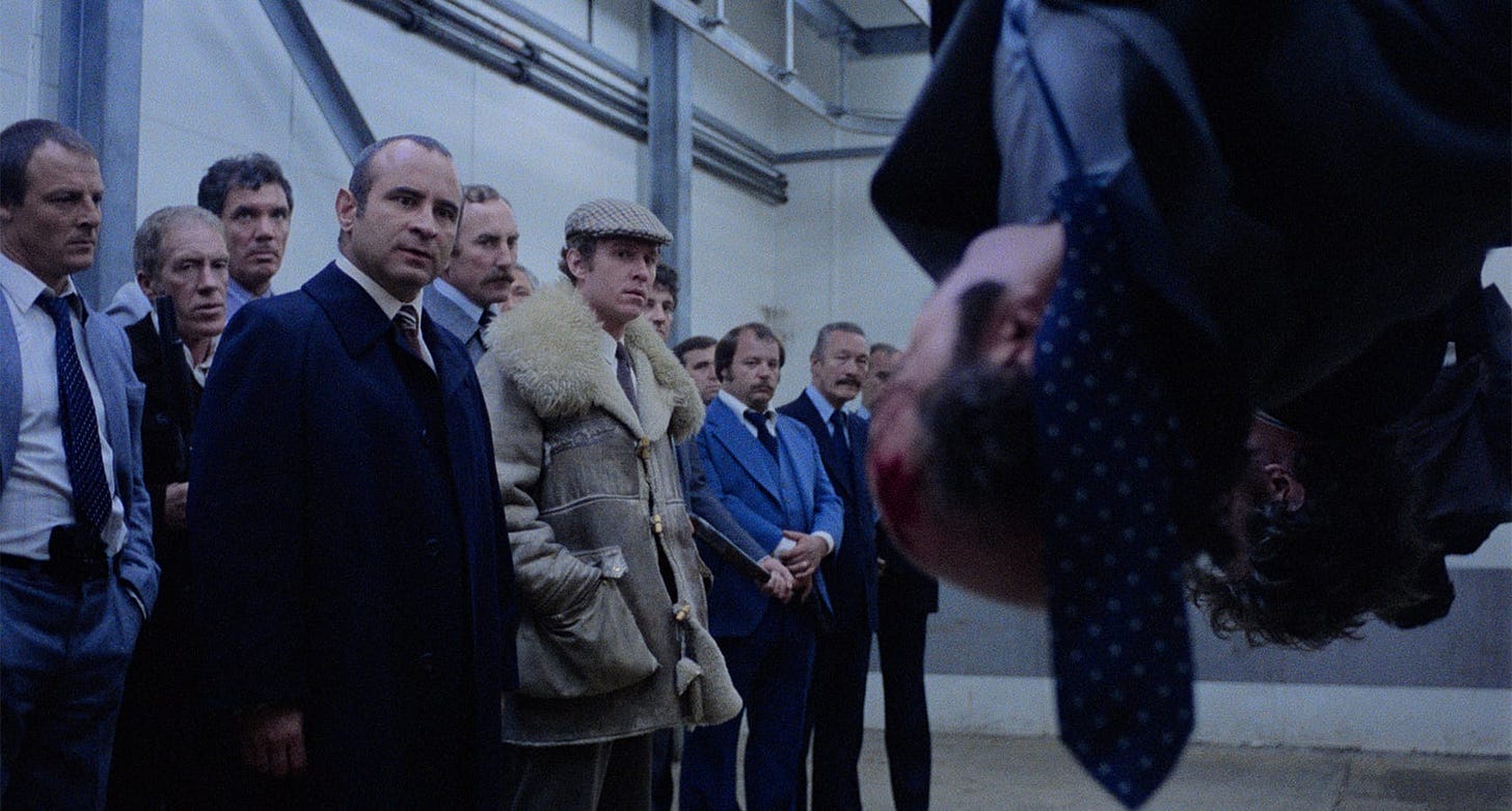 The Long Good Friday | Still features Bob Hoskins observing a man hung upside down in a meat factory.