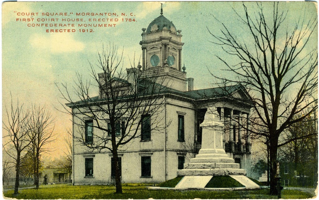 Photo of the Historic Burke County Courthouse withe Confederate monument before having the soldier placed on top.